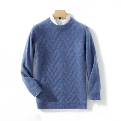 Blue sweater with a zigzag pattern on a hanger against a white background