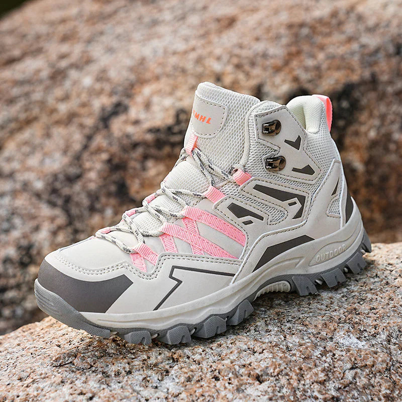 Gray and pink hiking boot on a rocky surface