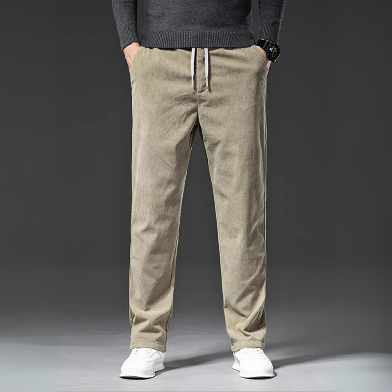 Beige pants worn by a person on a gray background