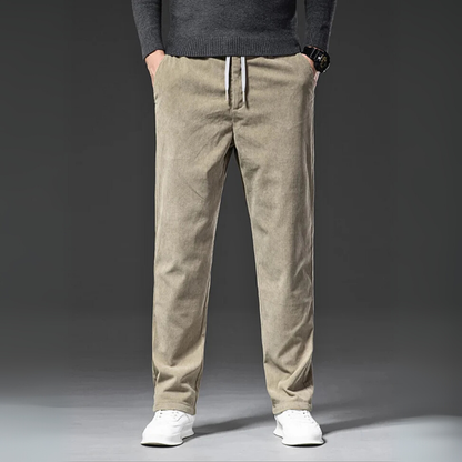 Beige pants worn by a person on a gray background