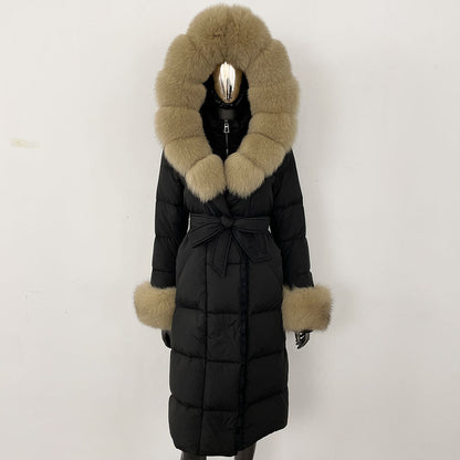 Black puffer coat with fur trim on a white background