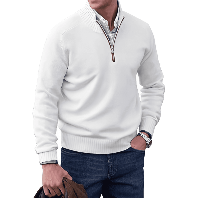 Man wearing a white quarter-zip sweater with a plain background