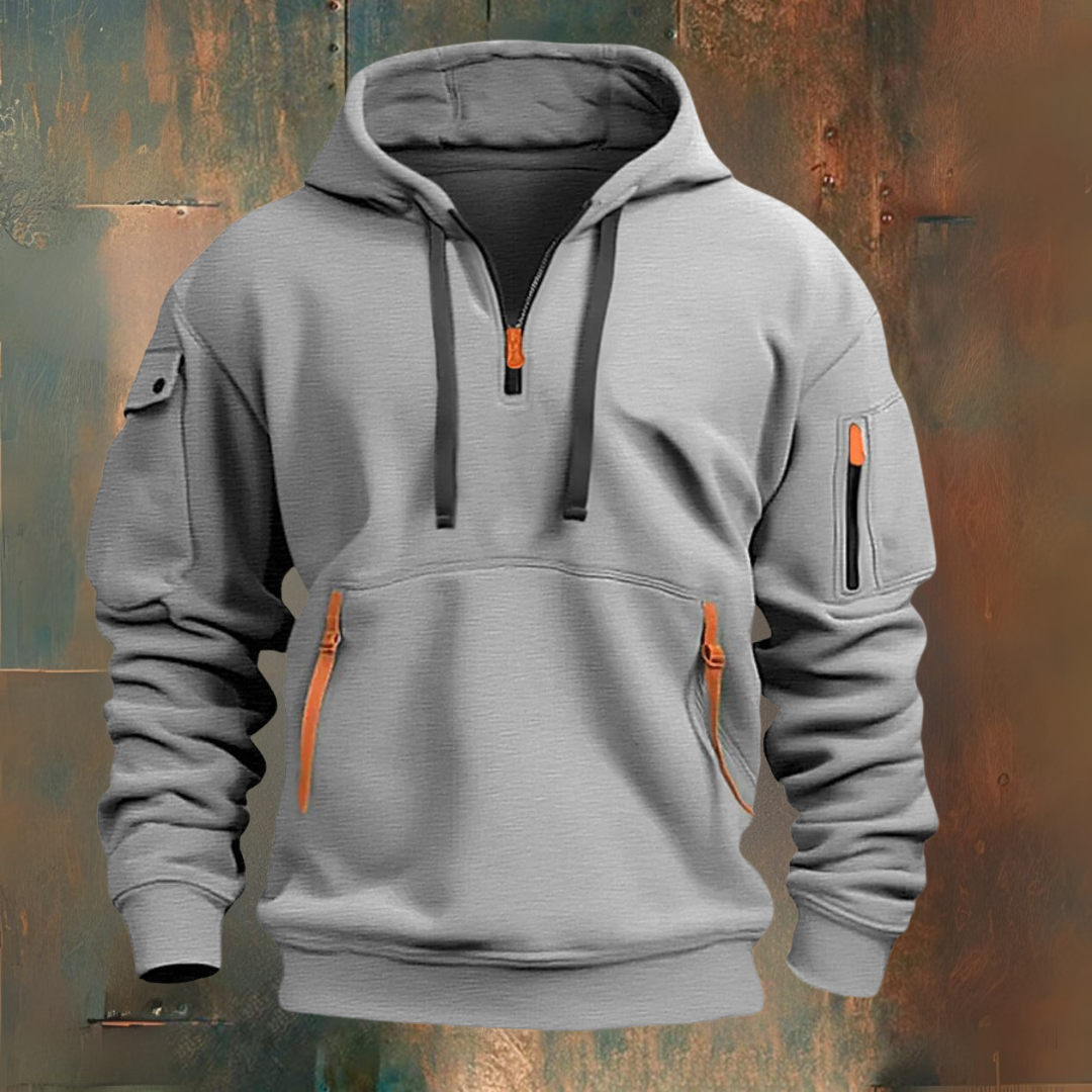 Gray hoodie with orange zippers on a textured background