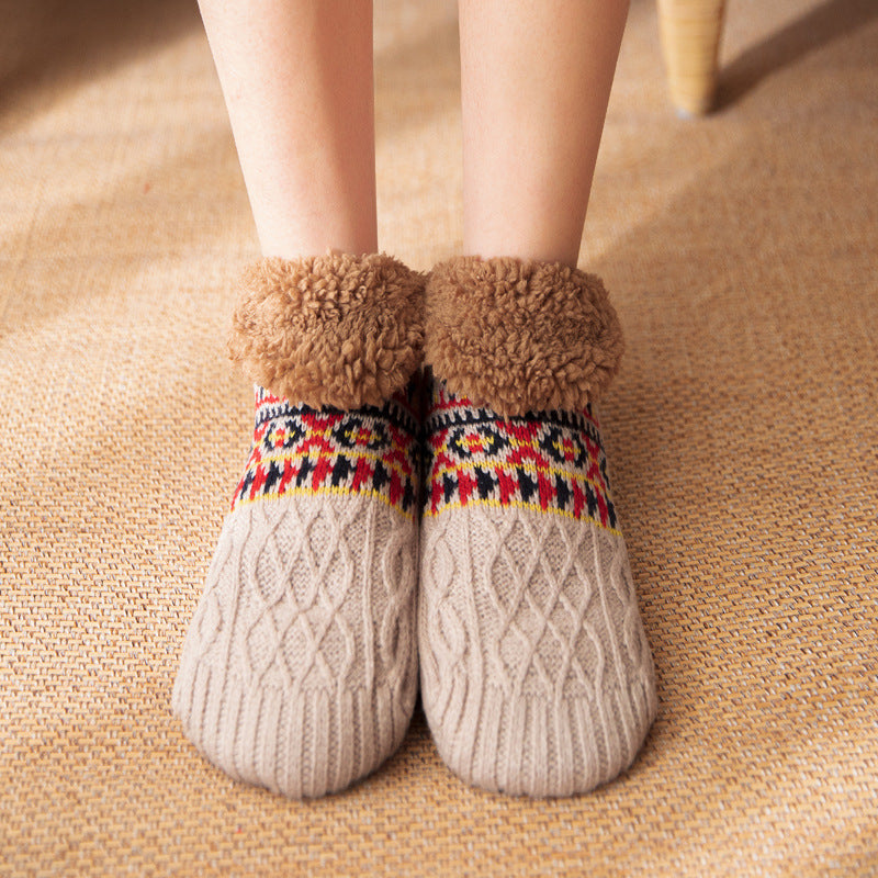 Beige socks with patterned cuffs on a textured surface