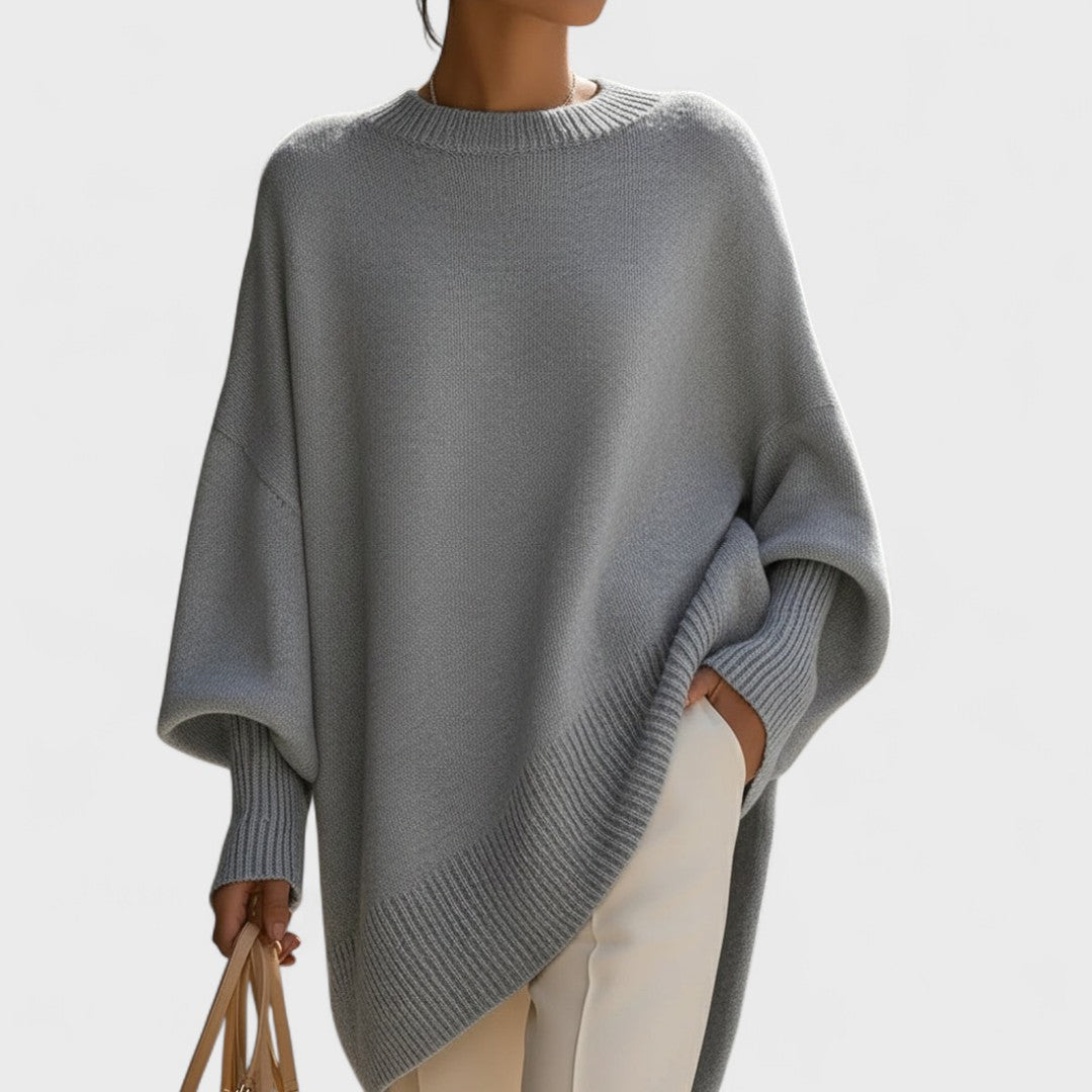 Gray poncho worn by a person on a light gray background