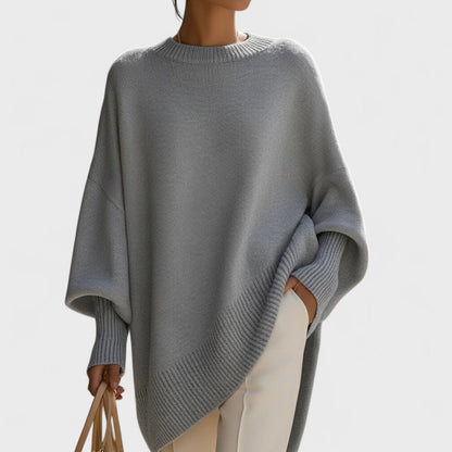 Gray poncho worn by a person on a light gray background