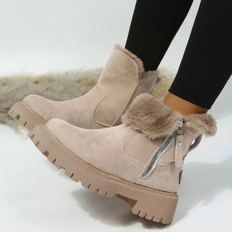 Beige winter boots with fur trim worn by a person on a light background