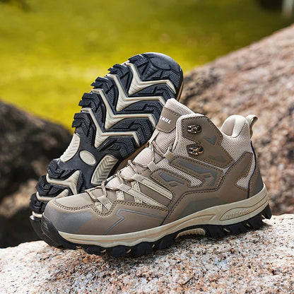 Pair of hiking boots on a natural rock surface with a blurred green background