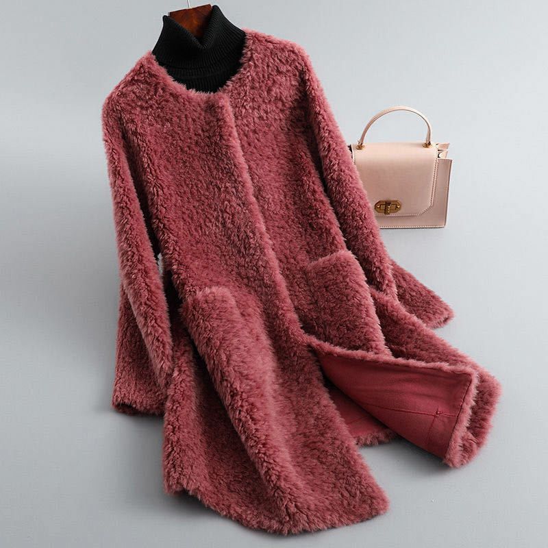 Pink fluffy coat on a mannequin with a pink handbag on a light gray background
