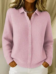 Pink knitted sweater worn by a person with a neutral background