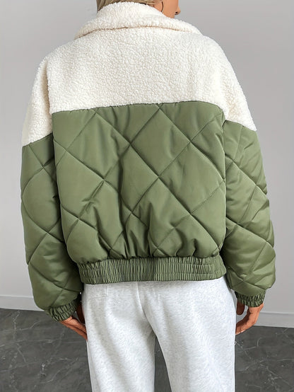 Green quilted jacket with white collar worn by a person on a gray background