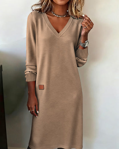 Beige sweater dress worn by a person against a plain background