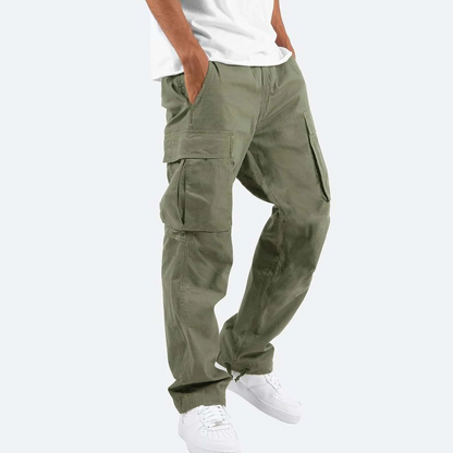 Person wearing olive green cargo pants on a white background