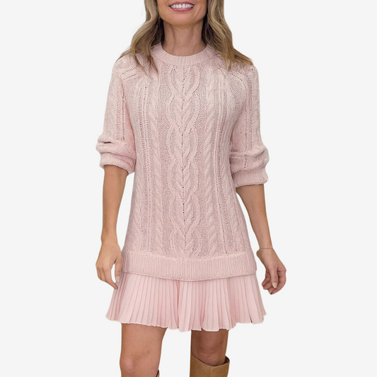 Woman wearing a pink cable knit dress on a white background