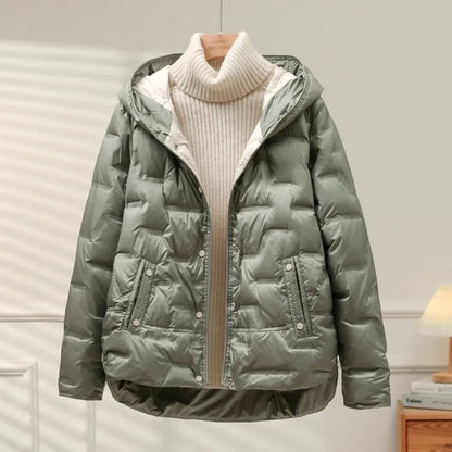 Green puffer jacket with a beige turtleneck sweater on a neutral background