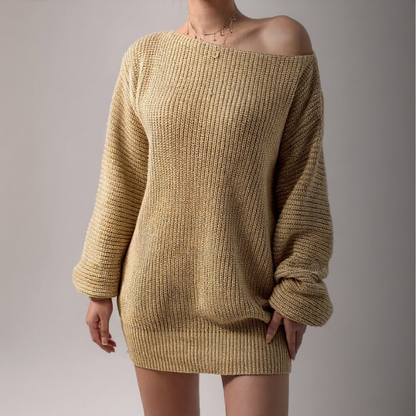 Beige knitted sweater dress worn by a person on a plain background