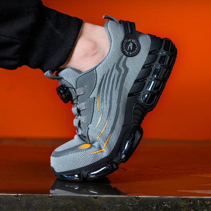 Gray and black sneaker with a brand logo on an orange background