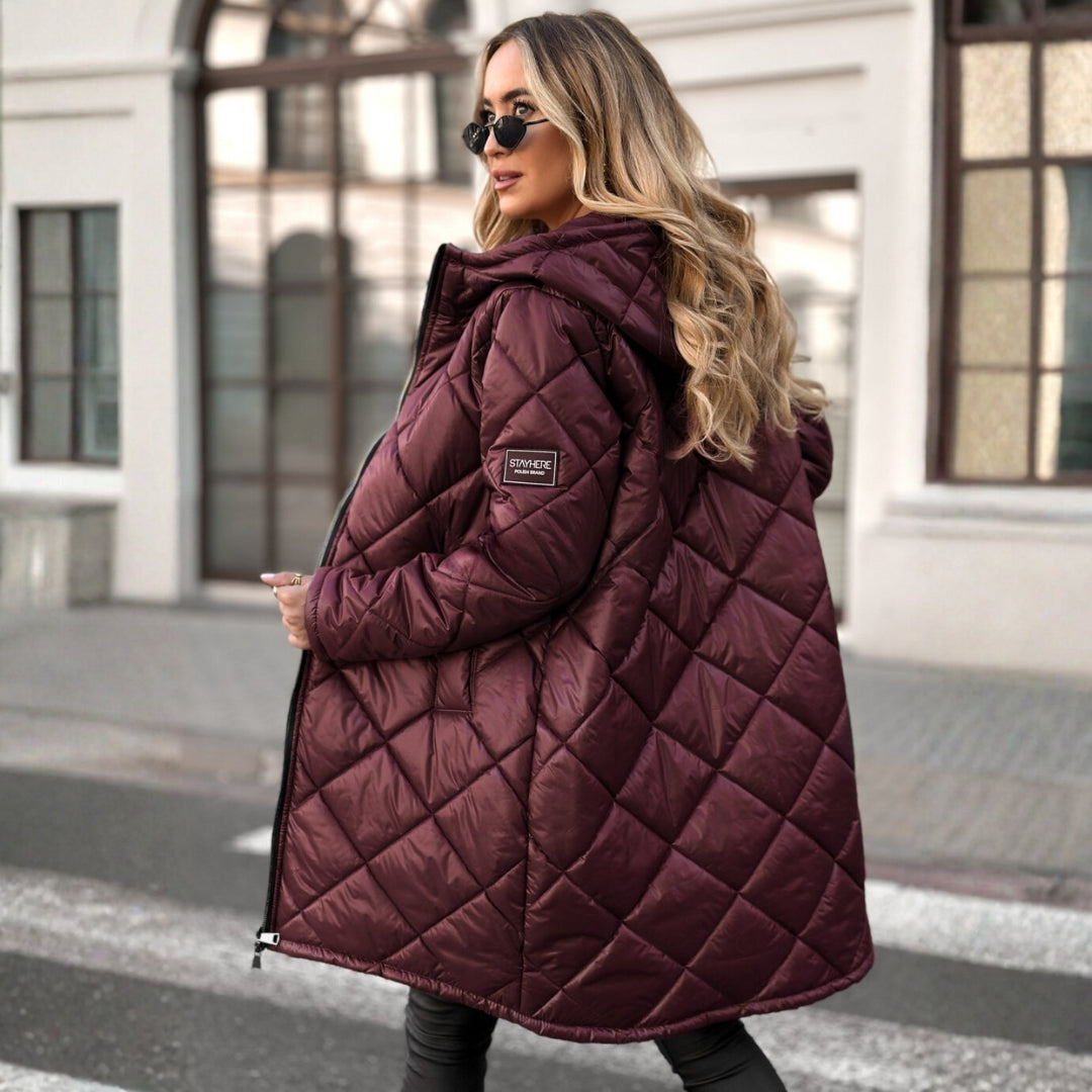 Woman wearing a quilted purple coat in an urban setting