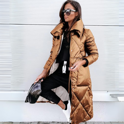 Woman wearing a long brown puffer coat against a white background