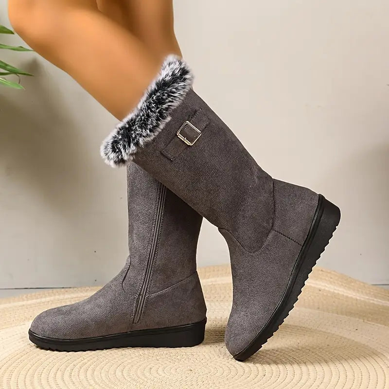 Gray knee-high boots with fur trim on a neutral background