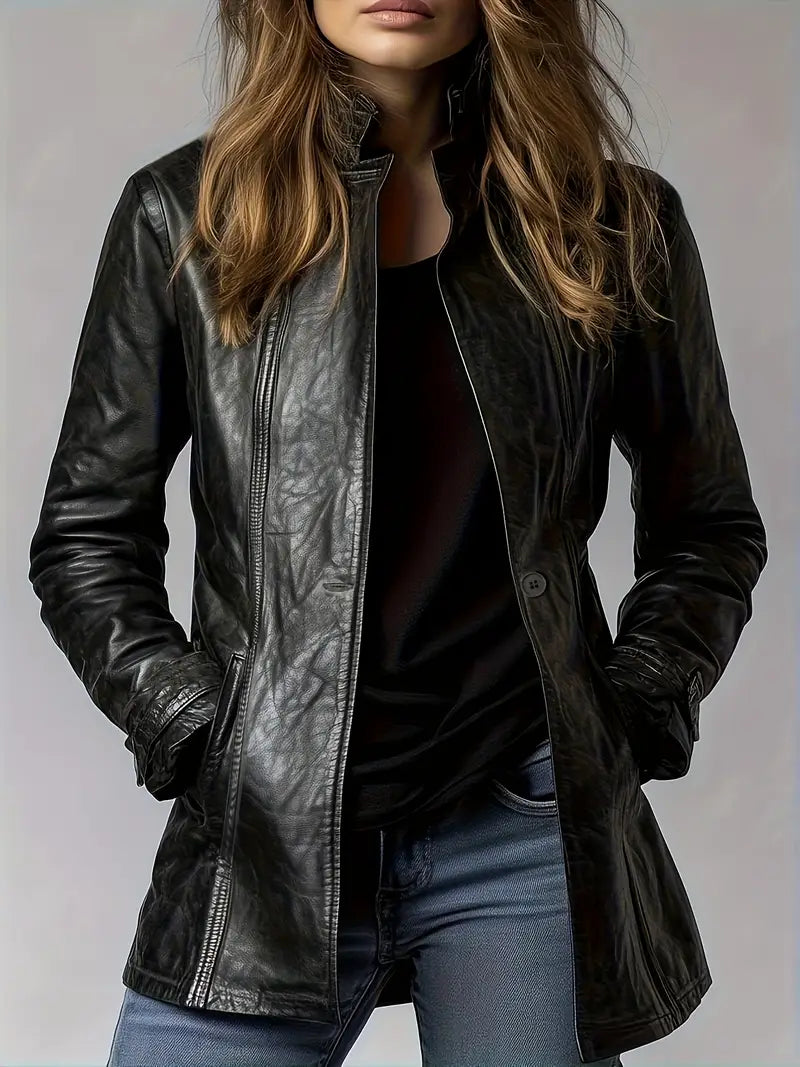 Person wearing a black leather jacket on a plain background