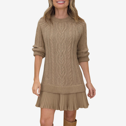 Woman wearing a beige cable knit dress on a white background