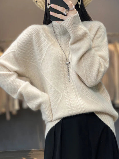 Person wearing a beige sweater with a blurred background