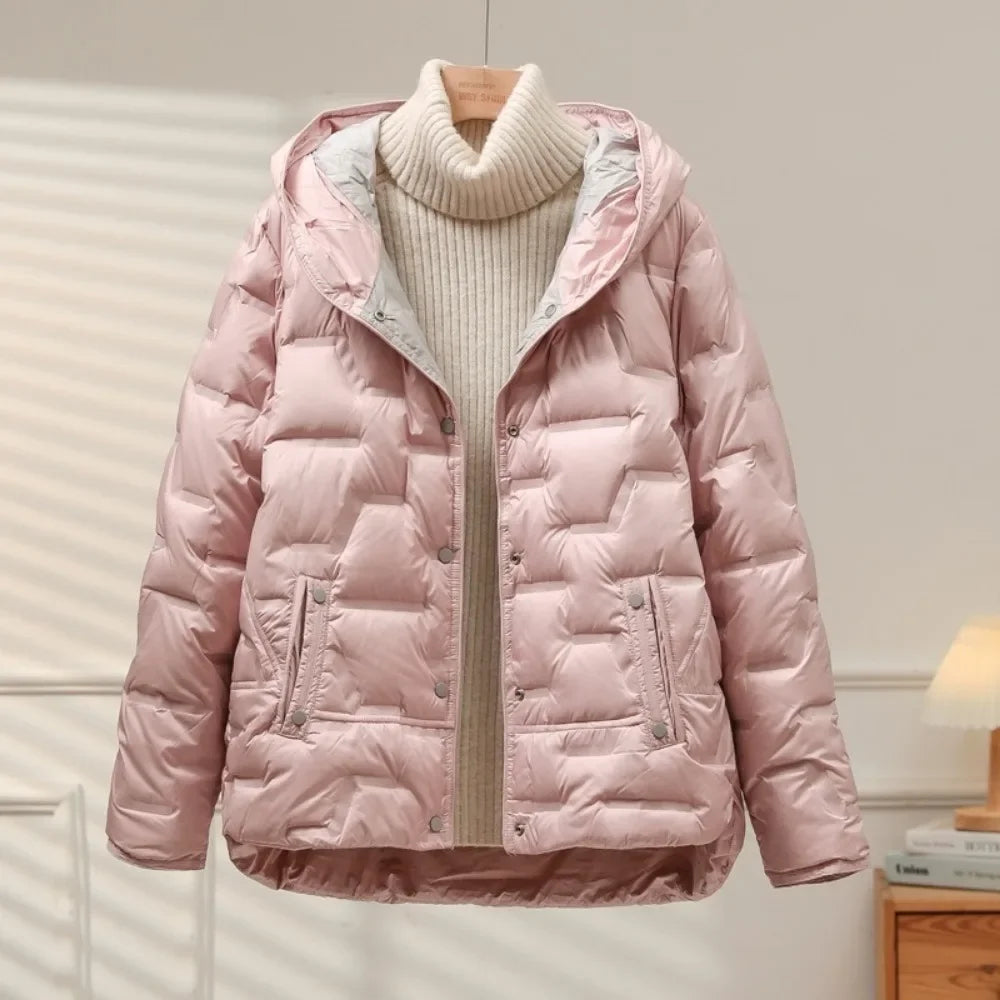 Pink puffer jacket on a wooden hanger against a neutral background
