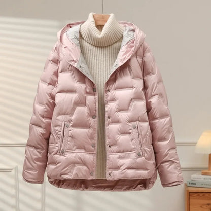 Pink puffer jacket on a wooden hanger against a neutral background