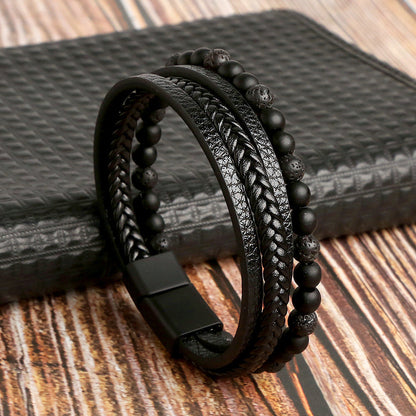 Black leather and beaded bracelet on a textured surface