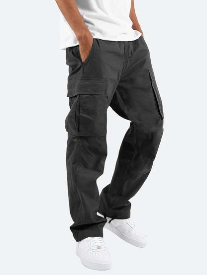 Person wearing black cargo pants on a white background