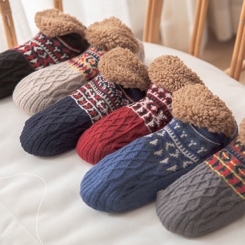 Set of colorful knitted socks with fuzzy trim on a light surface.
