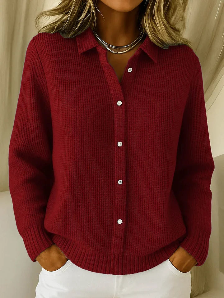 Red knitted cardigan worn by a person with a neutral background