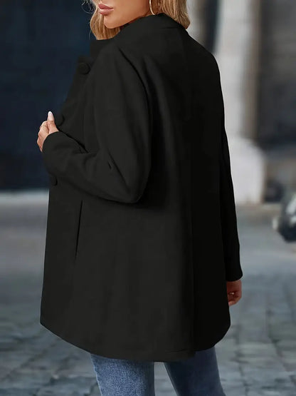 Person wearing a black coat on a blurred street background