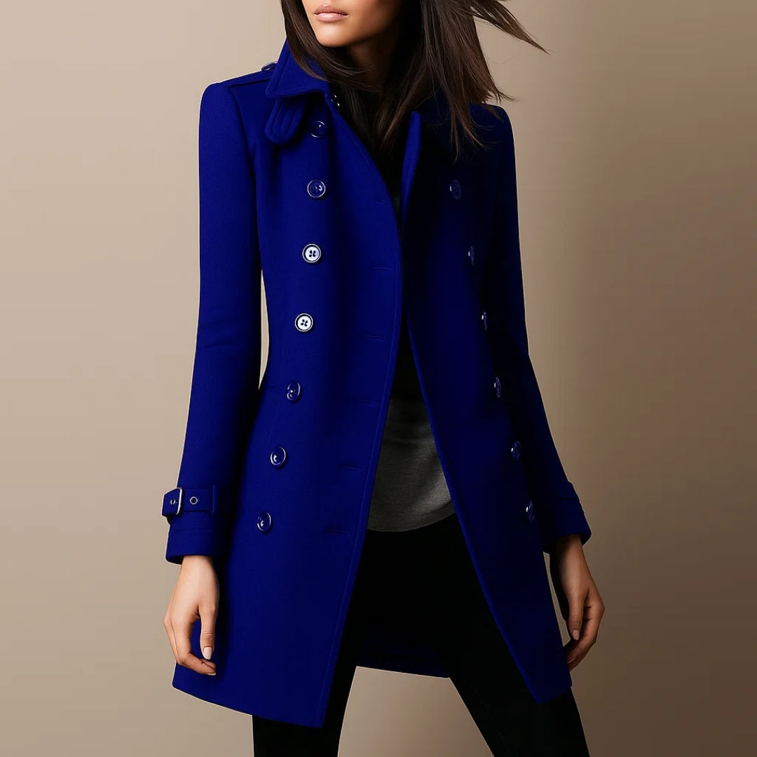 Blue coat worn by a person on a beige background