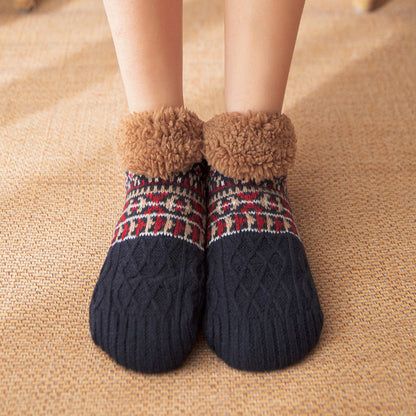 Plaid patterned socks with fuzzy cuffs on a textured surface