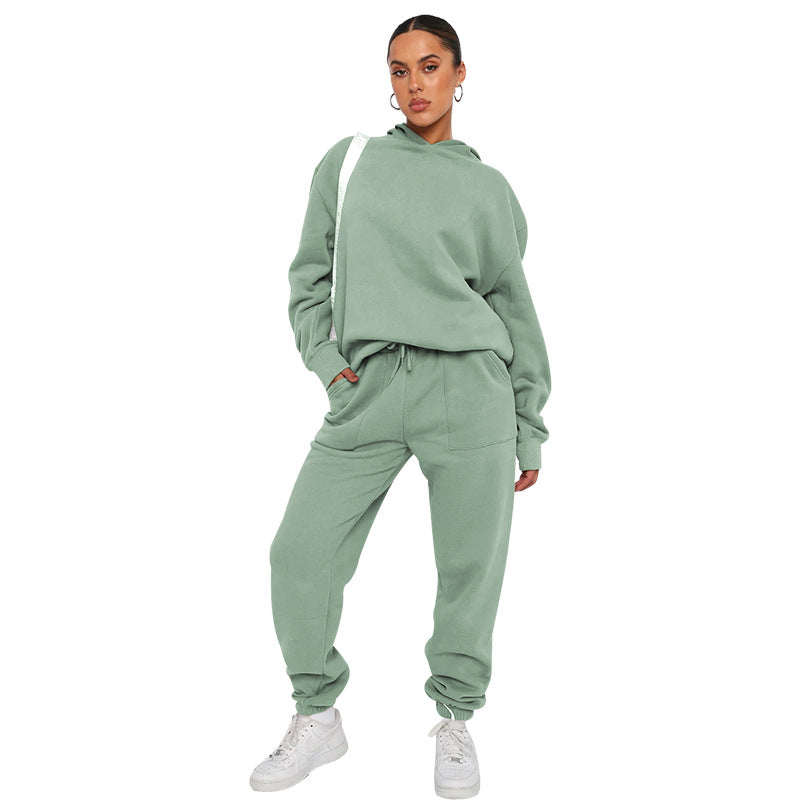 Person wearing a green tracksuit on a white background