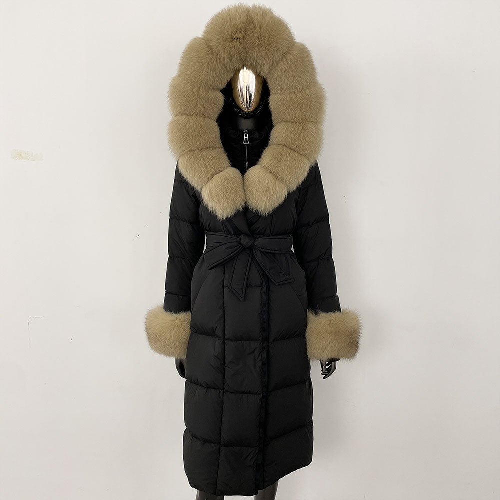 Black puffer coat with fur trim on a white background