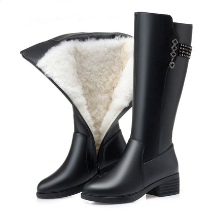 Black rain boots with white fur lining on a white background