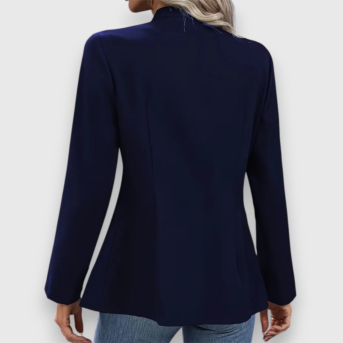 Navy blue blazer worn by a person on a white background