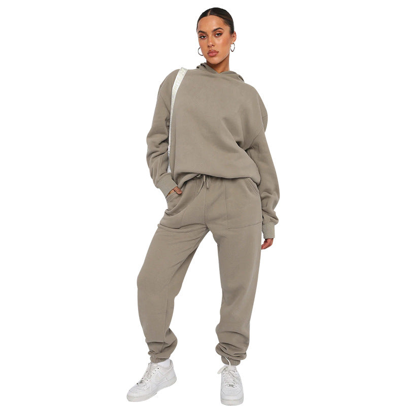 Woman wearing a beige tracksuit on a white background