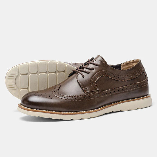 Brown leather shoe with white sole on a light gray background