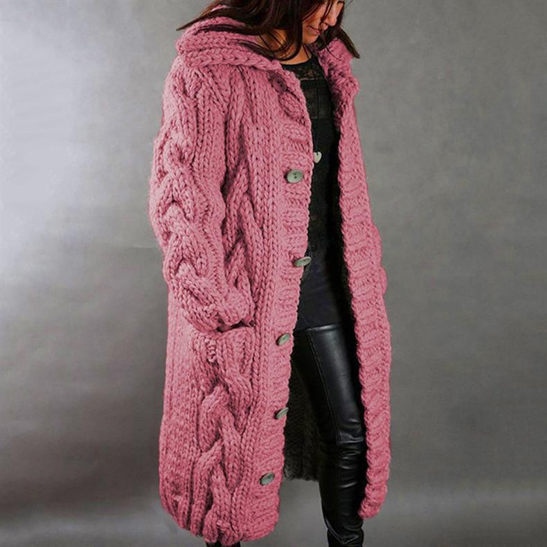 Pink knitted coat worn by a person on a gray background