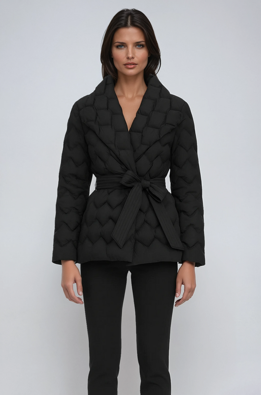 Woman wearing a black quilted jacket on a white background