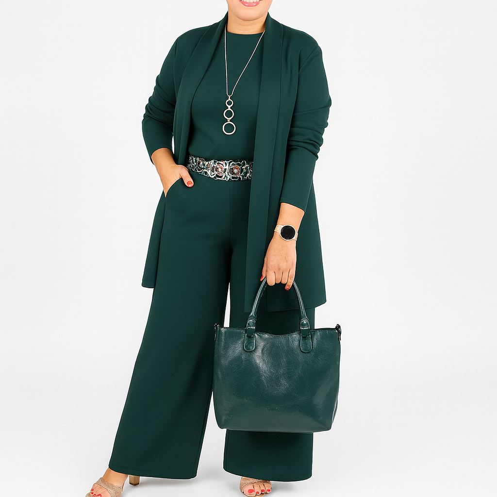Woman in a green outfit holding a matching handbag on a white background