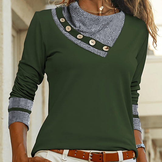 Green long-sleeve top with button details and gray collar worn by a person.