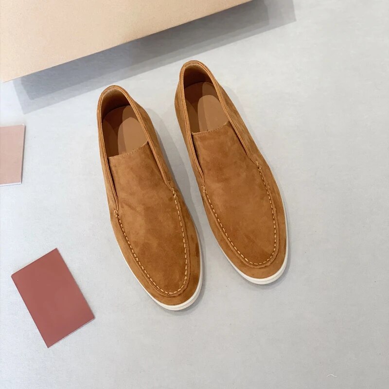Pair of brown loafers on a light gray surface with color swatches.