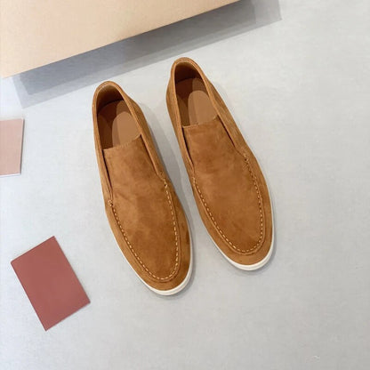 Pair of brown loafers on a light gray surface with color swatches.