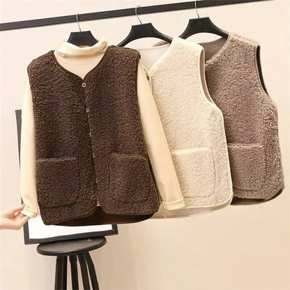 Three fleece vests in brown, beige, and gray on hangers against a white background.