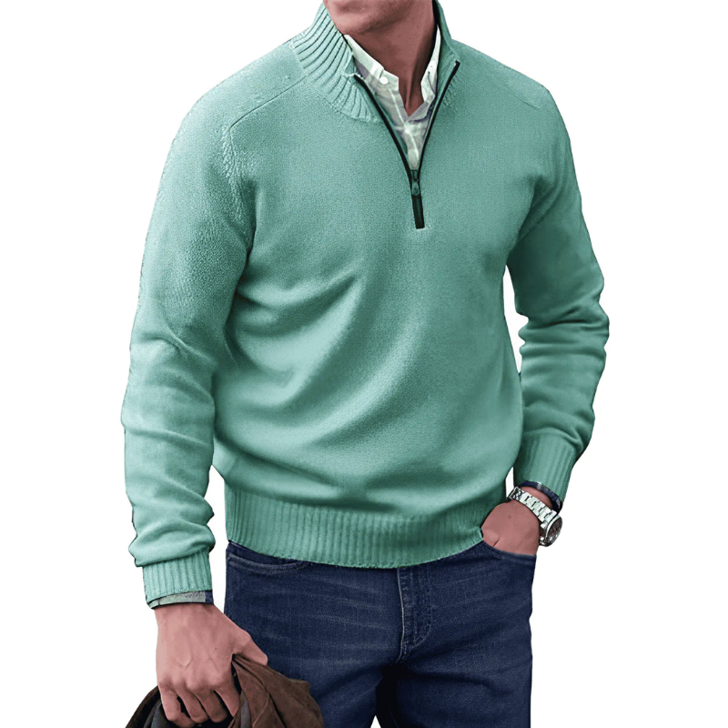 Man wearing a light green sweater with a quarter zip on a white background